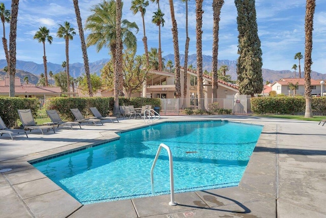 view of pool with a mountain view and a patio area