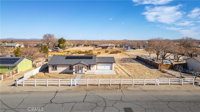 view of front of property with a garage and a rural view