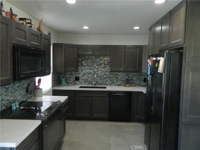 kitchen featuring sink, black appliances, and tasteful backsplash