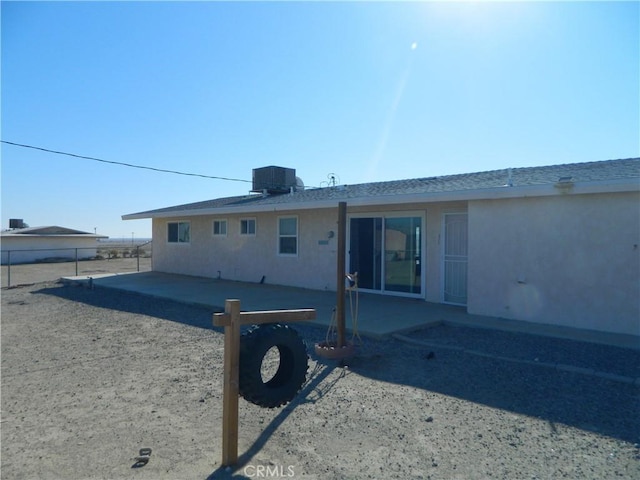 rear view of house featuring central AC and a patio