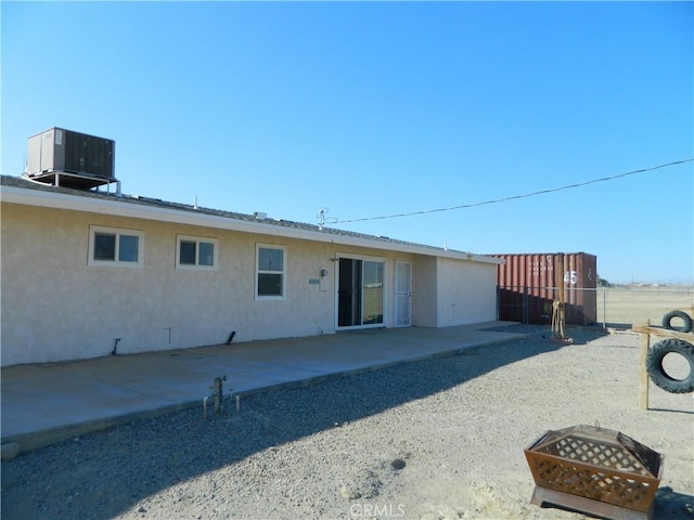 exterior space featuring an outdoor fire pit, central AC, and a patio area