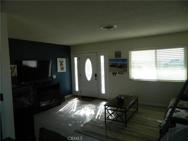 foyer entrance with a textured ceiling