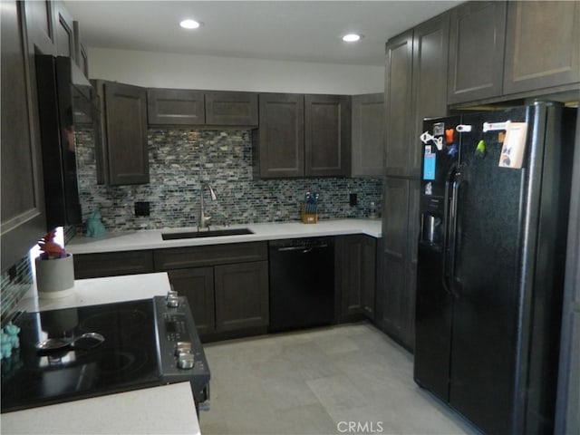 kitchen with black appliances, dark brown cabinetry, decorative backsplash, and sink