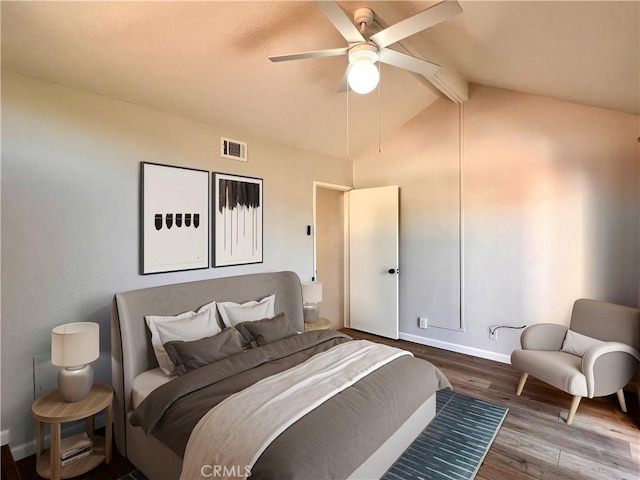 bedroom featuring hardwood / wood-style floors, lofted ceiling with beams, and ceiling fan