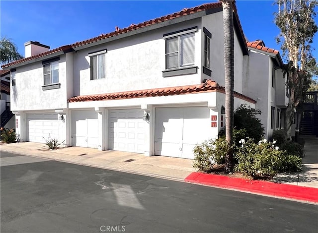 mediterranean / spanish-style home featuring a garage