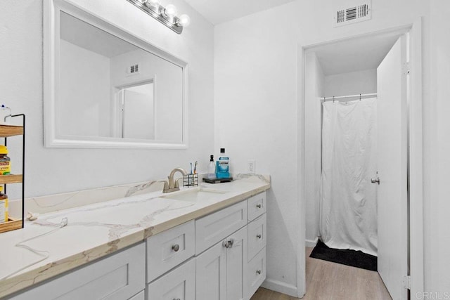 bathroom with vanity and hardwood / wood-style flooring