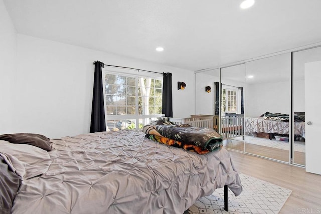 bedroom with a closet and light hardwood / wood-style floors