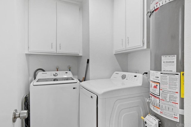 laundry area featuring gas water heater, cabinets, and washing machine and clothes dryer