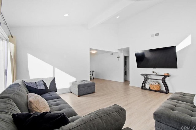 living room with light hardwood / wood-style floors and beam ceiling