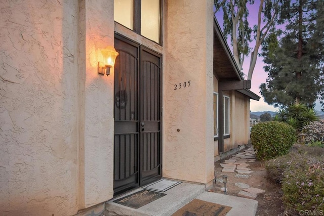 view of exterior entry at dusk