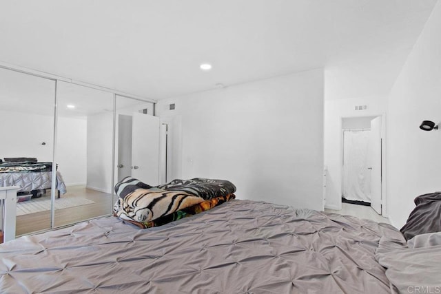 bedroom with a closet and light hardwood / wood-style floors