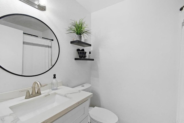 bathroom featuring toilet and vanity