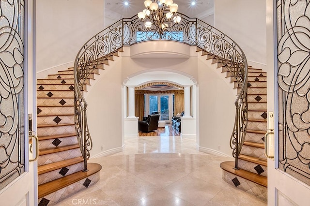 entrance foyer featuring an inviting chandelier and a high ceiling