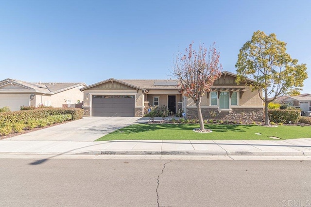 view of front of property featuring a garage, a front yard, and solar panels