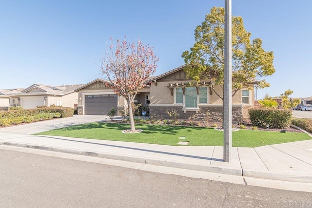 view of front of home with a garage and a front lawn