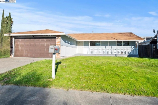 ranch-style home with a garage and a front yard