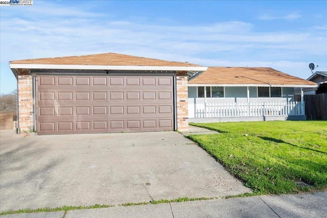 ranch-style home with a garage and a front lawn