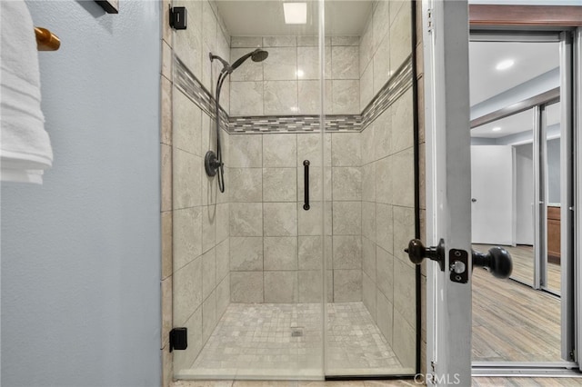 bathroom featuring a shower with door