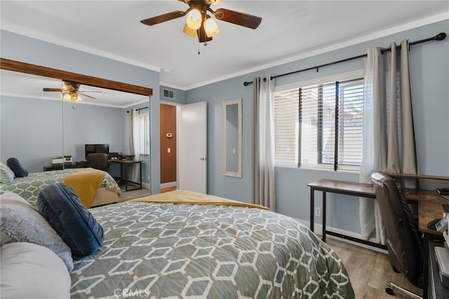 bedroom with ceiling fan, light hardwood / wood-style flooring, and ornamental molding