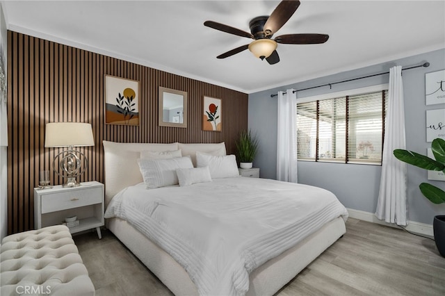 bedroom featuring ornamental molding, ceiling fan, and hardwood / wood-style floors