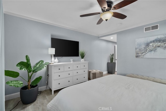 bedroom with ceiling fan and ornamental molding