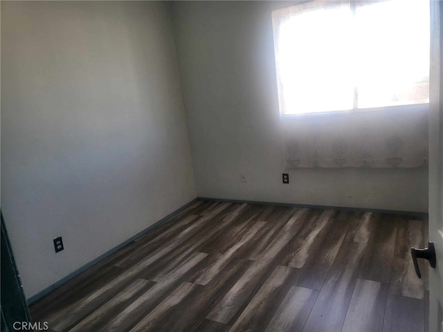 unfurnished room featuring dark wood-type flooring