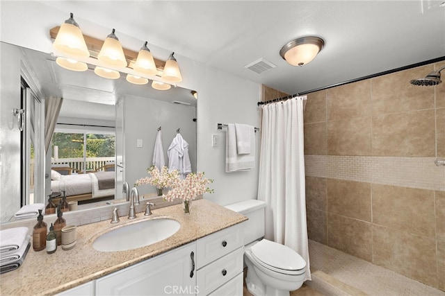 bathroom with a shower with curtain, vanity, and toilet