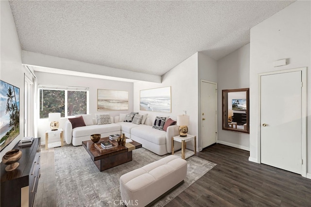 living room with dark wood-type flooring and a textured ceiling