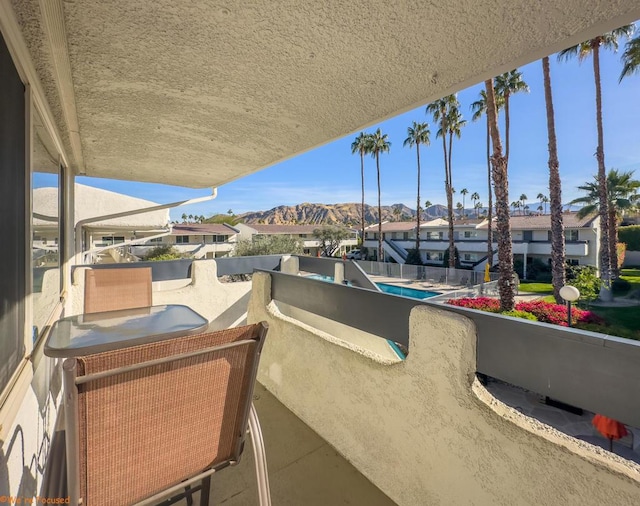 view of patio / terrace with a balcony and a mountain view