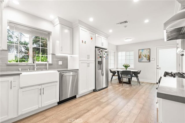 6770 Oak Ave, Arcadia, CA 91007 - kitchen featuring appliances with stainless steel finishes, a sink, wall chimney exhaust hood, tasteful backsplash, and recessed lighting
