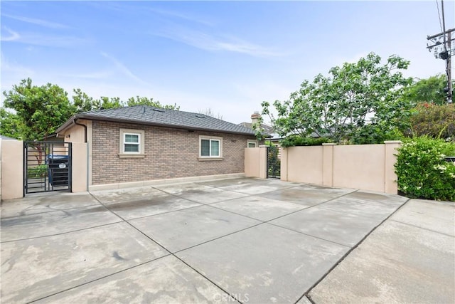 6770 Oak Ave, Arcadia, CA 91007 - rear view of house with a gate, brick siding, and a chimney
