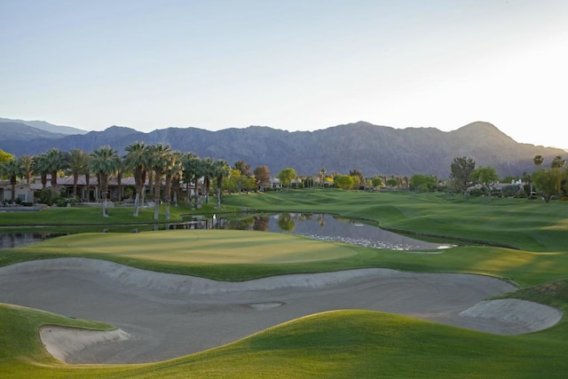 surrounding community featuring a water and mountain view and a yard