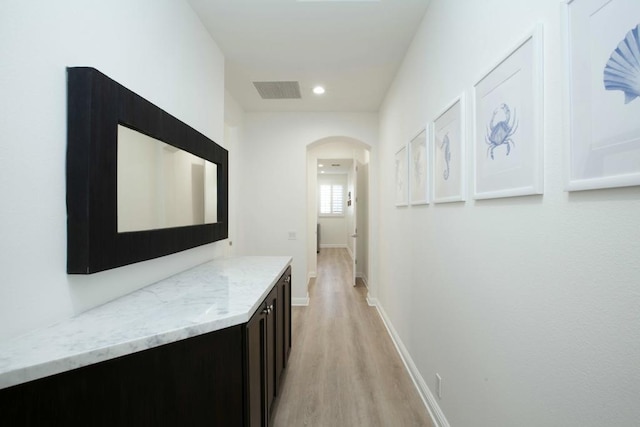 corridor with light hardwood / wood-style floors