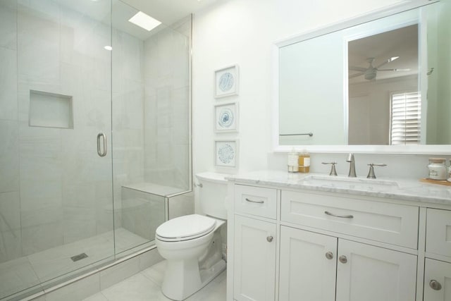 bathroom with walk in shower, vanity, toilet, and tile patterned flooring