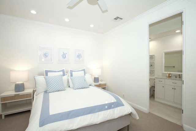 bedroom featuring crown molding, ceiling fan, light carpet, and ensuite bath