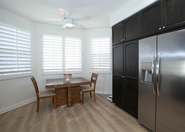 dining space with ceiling fan and light wood-type flooring