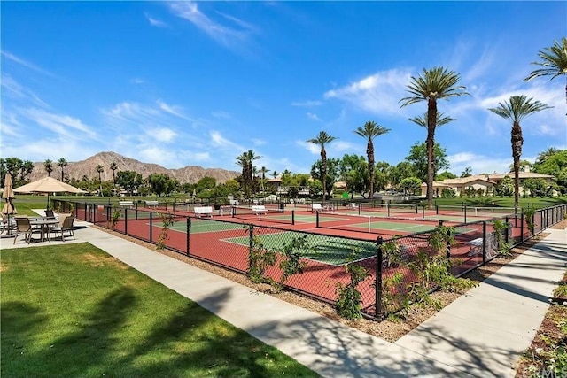 view of tennis court featuring a mountain view