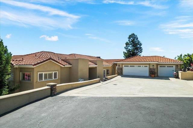 mediterranean / spanish house with a garage