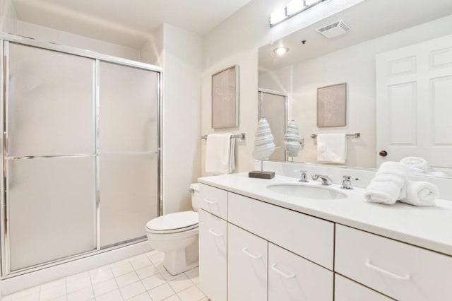 bathroom featuring vanity, toilet, tile patterned floors, and a shower with door