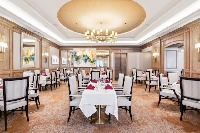 dining area featuring a chandelier and a tray ceiling