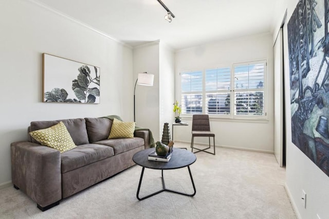 living room featuring light colored carpet, track lighting, and ornamental molding