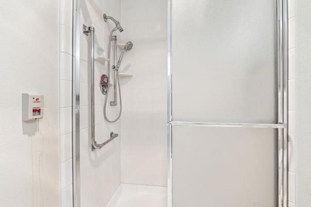 bathroom with a shower with shower door