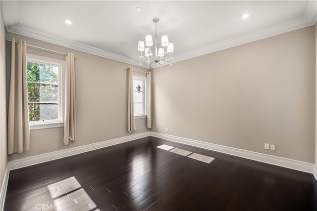 empty room featuring dark wood-type flooring, a chandelier, and ornamental molding