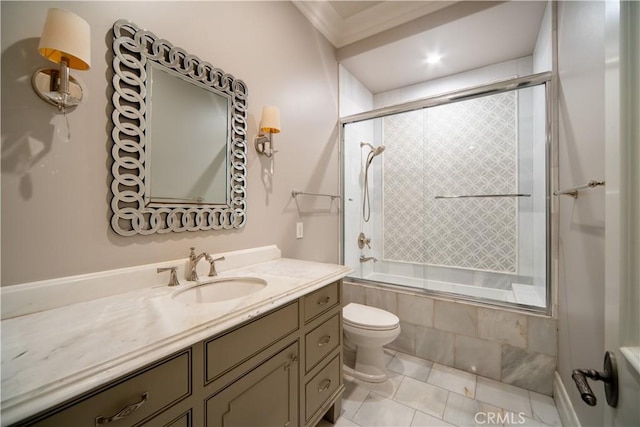 full bathroom featuring toilet, enclosed tub / shower combo, crown molding, tile patterned flooring, and vanity