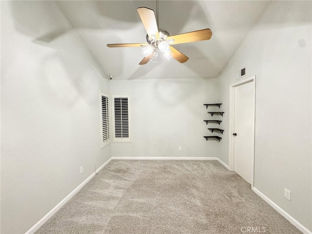 carpeted empty room featuring ceiling fan and vaulted ceiling