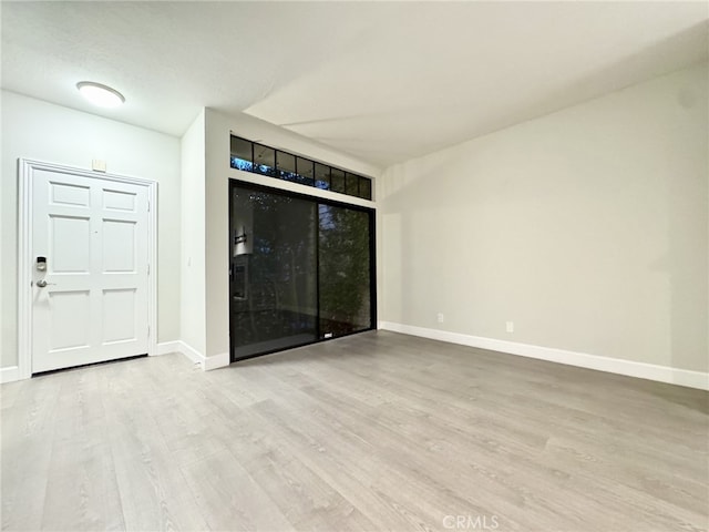 empty room with light hardwood / wood-style flooring