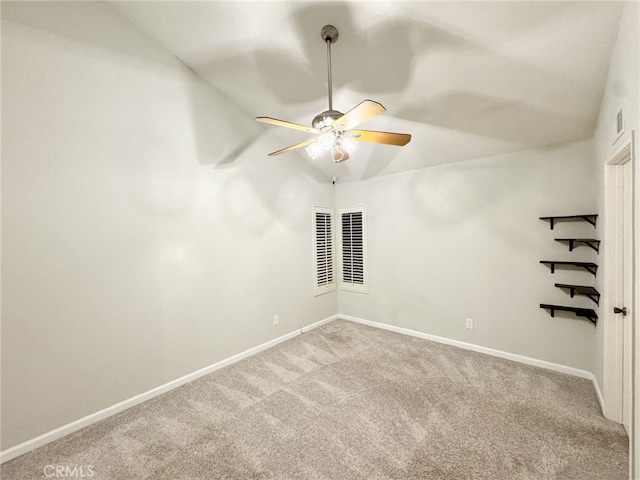 empty room with light colored carpet, vaulted ceiling, and ceiling fan