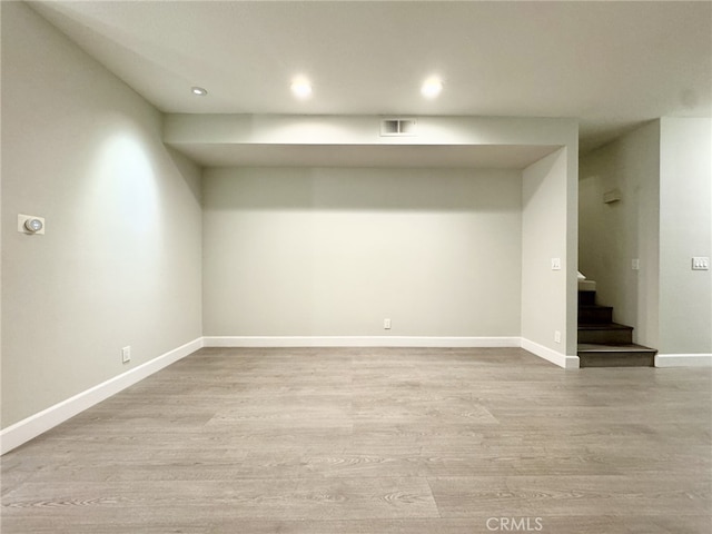 basement with light hardwood / wood-style floors