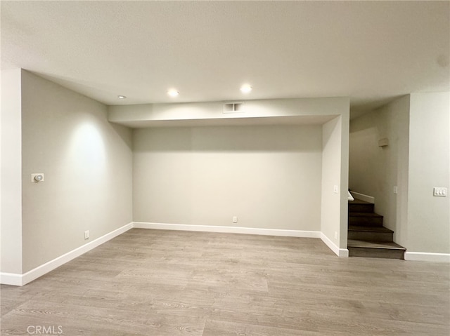 basement featuring light hardwood / wood-style flooring