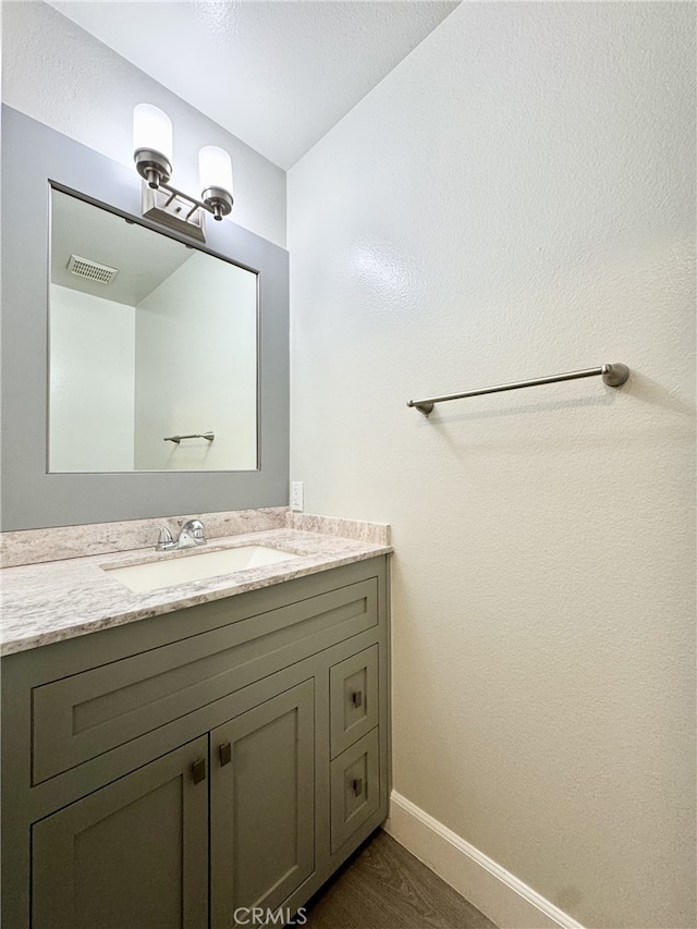 bathroom featuring vanity and wood-type flooring